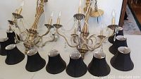 Pair of older chandeliers with cream/beige wooden frames, black fabric shades, candle-style bulbs, and hanging crystal accents