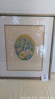 Framed floral etching artwork displayed upright on a table with lot number 59.