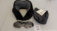 Memory foam travel pillow, black carry bag, and sealed black sleep mask to show included items and condition.