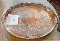 Top view showing the ornate embossed pattern across the tray surface with an intact silver finish.