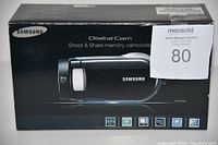 Box showing Samsung branding and camcorder image with 34x zoom text, indicating digital camcorder.