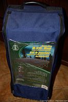 Soft sided navy blue carry bag with handle and transparent front displaying label