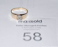 Ring face showing square cluster of nine diamonds on bid card