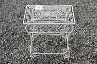 Front and top view of the small wrought iron garden patio side table showing detailed scrollwork on rectangular top and curved legs