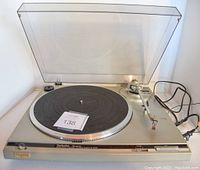 Full view of Technics SL-Q200 turntable with dust cover open, tonearm, platter, and power cable visible.