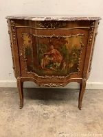Front view of commode showing painted pastoral scene panels and marble top
