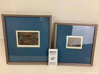 Two framed art prints side by side showing matting and frames with visible signatures and edition markings.