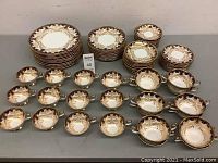 Overall view of 84-piece set arranged showing plates, bowls, cups and saucers