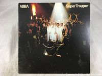 Front cover of Abba Super Trouper vinyl record album showing album title and group photo with spotlight effect.