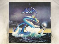 Front cover of Asia self-titled album showing iconic cover art with sea serpent and orb on water with dark clouds and horizon.
