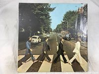 Front cover of Abbey Road album showing Beatles crossing the street.