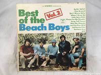 Front cover of Best of the Beach Boys Vol. 2 album showing band photo and select track names.