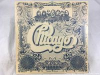 Photo of the Chicago VI album cover with ornate pattern and group photo of band members.