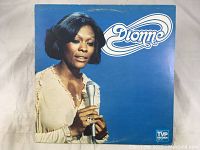 Front cover of Dionne Warwick's 'Dionne' vinyl LP record album featuring her image and logo.