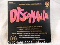 Front cover of Discomania album with title and some text.