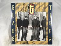 Front cover of The Thin Red Line album by Glass Tiger, showing band members in a winter forest.