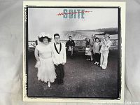 Album cover showing band members with a scenic backdrop