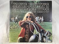 Front cover of Janis Joplin's Greatest Hits vinyl album showing Janis Joplin on motorcycle.