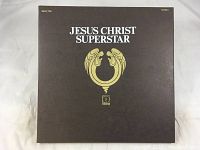 Front cover of the Jesus Christ Superstar British version 2 record vinyl LP set showing the title and a symbolic logo on a brown background.