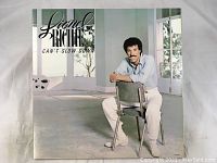 Album cover showing Lionel Richie seated on a metal chair in a bright room, with the title and artist's name.