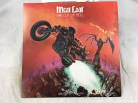 Front cover of Meatloaf's Bat Out of Hell vinyl album with dramatic illustration of motorcyclist and flames.