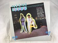 Front cover of Miami Vice TV show soundtrack album showing artwork and artist names.