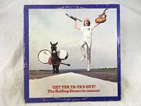 Front cover of The Rolling Stones 'Get Yer Ya-Ya's Out!' album showing a person jumping with a guitar and a donkey carrying drums.