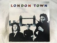 Front album cover showing Wings band members with Tower Bridge in background and title 'LONDON TOWN'.