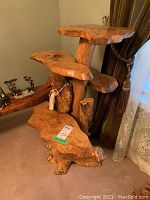 Front-left angle showing all four shelves ascending around the central trunk