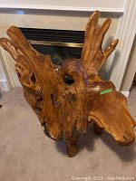 Front left three-quarter view showing antler-style backrest, concave seat and overall form