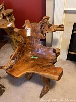 Front view of teak root chair showing seat area, natural edges and backrest formation