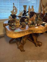 Full view of live-edge teak slab top and root base beneath, with tabletop cleared