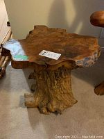 Front angle of tree root side table showing top surface and base.