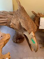 Front-left angle view showing head, beak, wings and base