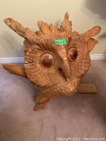 Front view of full owl sculpture showing overall shape, carving details, and base