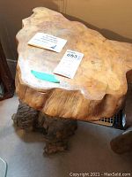 Full view of side table showing organic live-edge top surface and root base