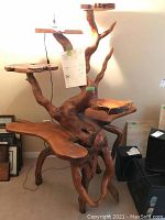 Full front view of carved teak shelving unit showing overall structure and multiple platforms