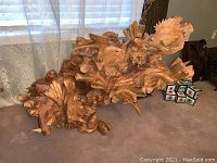 Front view of entire wood carving showing coral reef and multiple fish details