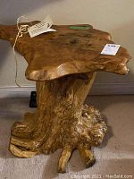 Side profile showing live-edge top and root base against wall