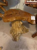 Front view showing tabletop slab and root base