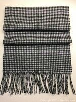 Full view of the folded scarf showing the black, grey, and lavender check pattern along with fringes at the bottom end.