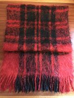 Folded view showing the cranberry red and black check pattern with fringe.