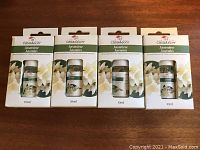 Four unopened 10ml vials of Casadécor Jasmine Refresher Oil in original packaging arranged side by side on a wooden surface.