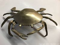 Solid brass crab ashtray closed showing detailed crab shape and legs.