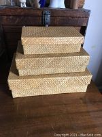 Three rectangular nesting rush boxes stacked one on top of the other, showing size difference and craftsmanship.