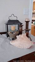 Two metal and wooden candle holders, large seashell and decorative fountain with candle and stones