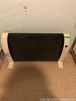 Front view of the black and white Noma digital space heater showing whole unit.