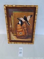 Front view of framed artwork showing figure with bird and signature bottom right.