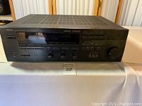 Front full view of Yamaha RX-V590 A/V receiver showing power button, input selector, and control knobs.