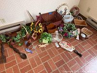 Wide view of lot showing all baskets, faux greenery, wall hangings and bun warmer bag on brick floor near corner